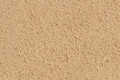 Naheaufnahme von strukturiertem Putz in einem sandfarbenen Ton, ideal für dekorative Wandoberflächen und Fassaden.