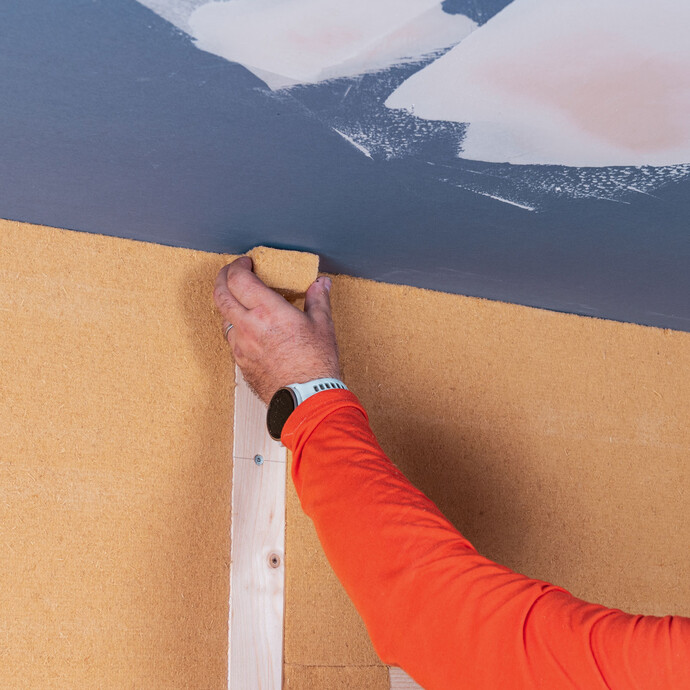 Innendämmung mit Tragkonstruktion selber bauen - erste Dämmebene: Die Lücken im Stoßbereich des Kantholzes wird mit Dämmmaterial sorgfältig verschlossen.