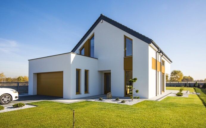 Maison individuelle avec façade en crépi blanc et surfaces de couleur jaune en quinconce